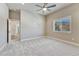 Bright bedroom with ceiling fan and a large window offering mountain views at 93 Greeley Blvd, Palmer Lake, CO 80133