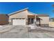 Charming stucco home featuring a two-car garage, covered entry, and well-manicured landscaping at 93 Greeley Blvd, Palmer Lake, CO 80133
