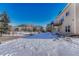 Home's exterior view features a deck and snow-covered yard, blending seamlessly with the natural surroundings at 93 Greeley Blvd, Palmer Lake, CO 80133