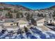 Aerial shot of two homes in a snowy community, each with a two-car garage at 93 Greeley Blvd, Palmer Lake, CO 80133