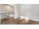 Modern hallway with wood floors, black metal railing and an open concept feel to the home at 93 Greeley Blvd, Palmer Lake, CO 80133