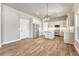 Bright kitchen featuring white cabinets, stainless steel appliances, an island, and wood floors at 93 Greeley Blvd, Palmer Lake, CO 80133