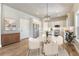 Open concept kitchen dining area featuring stainless appliances, island with barstool seating at 93 Greeley Blvd, Palmer Lake, CO 80133