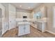 Well-lit kitchen showcasing white cabinets, stainless steel appliances, an island, and a mountain view at 93 Greeley Blvd, Palmer Lake, CO 80133