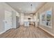 Bright kitchen featuring white cabinets, stainless steel appliances, an island, and wood floors at 93 Greeley Blvd, Palmer Lake, CO 80133