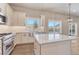 Bright kitchen featuring white cabinets, granite countertops, stainless steel appliances, and a scenic view at 93 Greeley Blvd, Palmer Lake, CO 80133