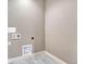 Empty laundry room features gray, tiled flooring and utility hookups at 93 Greeley Blvd, Palmer Lake, CO 80133
