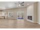 Open-concept living room with fireplace, wood floors, and sliding glass door to a deck at 93 Greeley Blvd, Palmer Lake, CO 80133