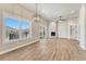 Bright living room featuring a fireplace, large windows with a scenic view, and hardwood floors at 93 Greeley Blvd, Palmer Lake, CO 80133