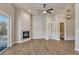 Well-lit living room featuring a fireplace, wood floors, and access to bathroom at 93 Greeley Blvd, Palmer Lake, CO 80133