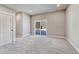 Living room with gray carpet flooring, neutral-colored walls and sliding glass door to the backyard at 93 Greeley Blvd, Palmer Lake, CO 80133
