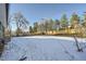 Spacious backyard with a snow-covered yard and trees at 71 W Fremont Ave, Littleton, CO 80120