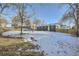 Large backyard with a wooden fence and snowy ground at 71 W Fremont Ave, Littleton, CO 80120