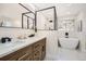 Elegant bathroom with double vanity, soaking tub, and walk-in shower at 71 W Fremont Ave, Littleton, CO 80120