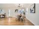 Modern dining area with light hardwood floors and a stylish dining set at 71 W Fremont Ave, Littleton, CO 80120