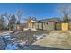 Modern home with gray brick exterior, wood accents, and landscaped yard at 71 W Fremont Ave, Littleton, CO 80120