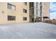 A building balcony with a light colored surface and glass-enclosed rooms at 7865 E Mississippi Ave # 105, Denver, CO 80247