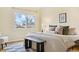 Bedroom featuring a comfortable bed, hardwood floors and an exterior view at 7865 E Mississippi Ave # 105, Denver, CO 80247