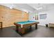 Recreation room featuring a billiards table with wooden accent wall and lighting at 7865 E Mississippi Ave # 105, Denver, CO 80247