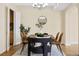 Dining room featuring hardwood floors, a modern chandelier, and a dining table with chairs at 7865 E Mississippi Ave # 105, Denver, CO 80247