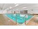 Large indoor swimming pool with clear water and ample natural light from surrounding windows at 7865 E Mississippi Ave # 105, Denver, CO 80247