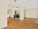 Living room with an archway leading to a dining area and hardwood floors throughout at 7865 E Mississippi Ave # 105, Denver, CO 80247