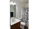 Functional bathroom with a shower/tub combo, toilet, vanity, and floral shower curtain at 11020 Glacier Park Cir, Parker, CO 80138