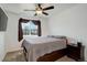 Cozy bedroom with a queen-size bed, ceiling fan, and natural light streaming through the window at 11020 Glacier Park Cir, Parker, CO 80138