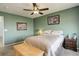 Comfortable bedroom featuring a ceiling fan, neutral tones, and a charming wood accent bench at 11020 Glacier Park Cir, Parker, CO 80138