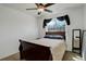 Bedroom featuring a ceiling fan, large window with neighborhood view, and hardwood floors at 11020 Glacier Park Cir, Parker, CO 80138