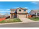 Charming two-story home with a two-car garage, landscaped lawn, and a vibrant blue sky backdrop at 11020 Glacier Park Cir, Parker, CO 80138