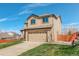 Two-story home with a two-car garage and a well-manicured lawn, set against a bright blue sky at 11020 Glacier Park Cir, Parker, CO 80138