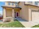 Inviting front entrance featuring a covered porch, well-kept lawn, and a glimpse of a red front door at 11020 Glacier Park Cir, Parker, CO 80138
