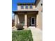 Inviting front porch featuring two white chairs, potted flowers, and a well-maintained lawn area at 11020 Glacier Park Cir, Parker, CO 80138
