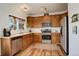This kitchen has stainless steel appliances, wood cabinets, and a functional layout at 11020 Glacier Park Cir, Parker, CO 80138