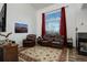 This spacious living room has a cozy fireplace and large windows, and comfortable seating at 11020 Glacier Park Cir, Parker, CO 80138