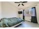 Simple bedroom with double bed, a mounted television, and natural light streaming from the window at 13960 Grape St, Thornton, CO 80602