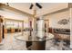 Open-concept living area with a glass dining table, leather sofa, and stylish decor at 13960 Grape St, Thornton, CO 80602