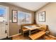 Cozy dining nook with wooden bench seating, natural light, and chili pepper artwork at 13960 Grape St, Thornton, CO 80602