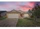 Charming single-Gathering home with a stone facade and a well-maintained front yard at sunset at 13960 Grape St, Thornton, CO 80602