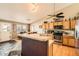 Well-lit kitchen with oak cabinets, stainless steel appliances, and a peninsula counter at 13960 Grape St, Thornton, CO 80602