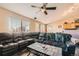 Open-concept living area featuring a large leather sectional sofa and dining area at 13960 Grape St, Thornton, CO 80602