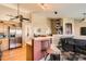 Open-concept living area with stainless refrigerator, bar seating, and decorative fireplace at 13960 Grape St, Thornton, CO 80602