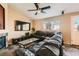 Comfortable living room features large leather sectional, fireplace, and flat screen television at 13960 Grape St, Thornton, CO 80602