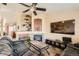 Open concept living space featuring a cozy fireplace, entertainment center, and comfortable seating at 13960 Grape St, Thornton, CO 80602