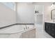 Bright bathroom features a soaking tub, tiled surround, and double vanity sink at 2990 S Juliet Ct, Strasburg, CO 80136