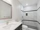 Modern bathroom featuring a tiled shower with a glass door and sleek fixtures at 2990 S Juliet Ct, Strasburg, CO 80136