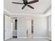 Bedroom featuring a ceiling fan and openings that lead to other rooms in the house at 2990 S Juliet Ct, Strasburg, CO 80136