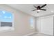 Well-lit bedroom features neutral walls, carpet, and a sliding door closet at 2990 S Juliet Ct, Strasburg, CO 80136