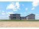 Two-story home exterior featuring neutral paint, a landscaped yard, and a clear blue sky at 2990 S Juliet Ct, Strasburg, CO 80136
